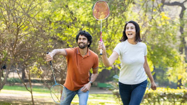 Couple playing racquetball together