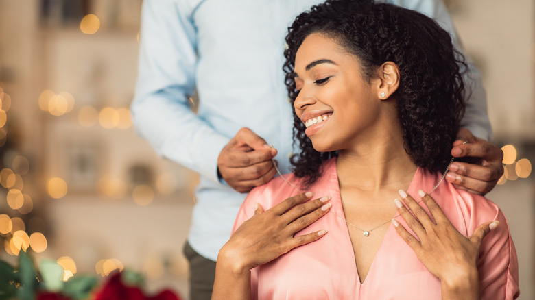 Happy woman eeceiving a gift