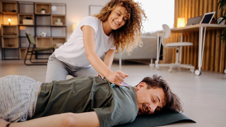 Woman giving her boyfriend a massage