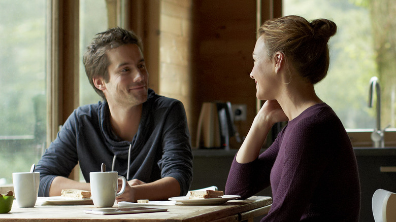 Happy couple talking over breakfast