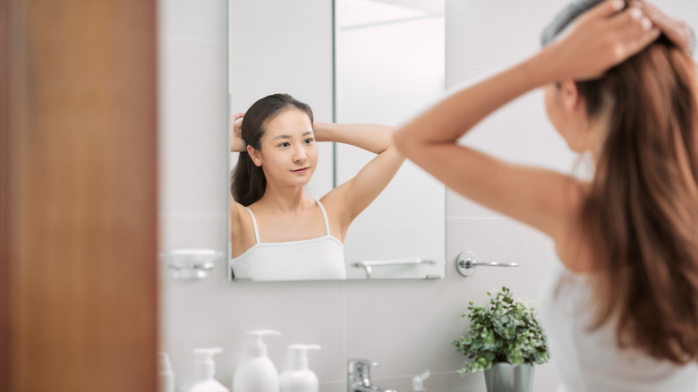 woman tying hair up