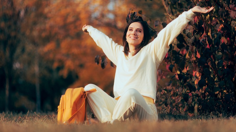 Woman stretches outdoors in athleisure 