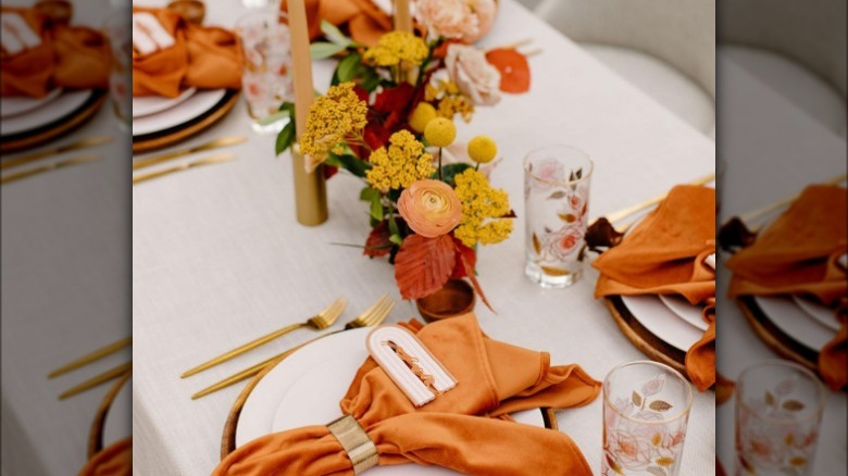 Orange and yellow reception table decor