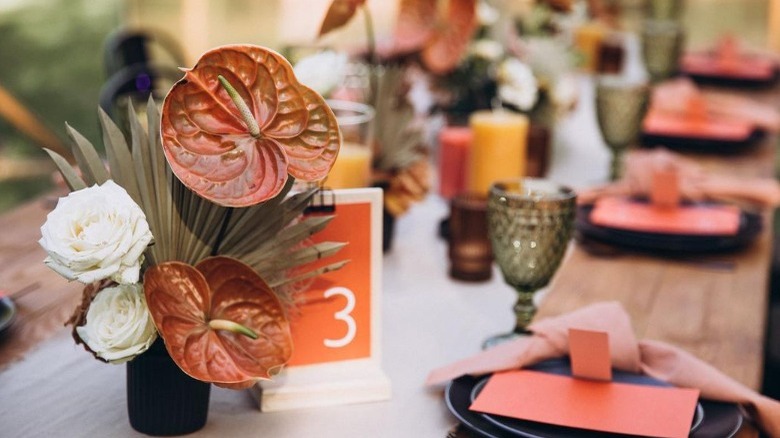 Wedding reception table with orange decor