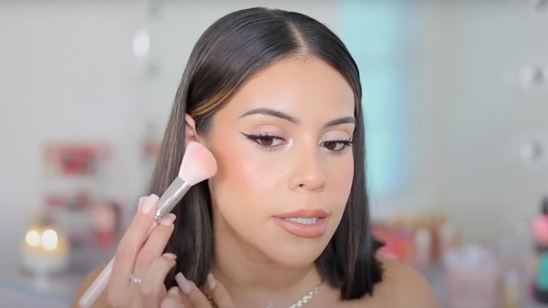 woman using angled contour brush