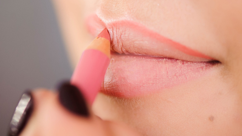 closeup applying lip liner