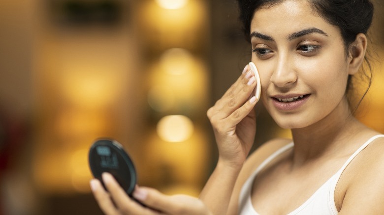 Woman applying makeup