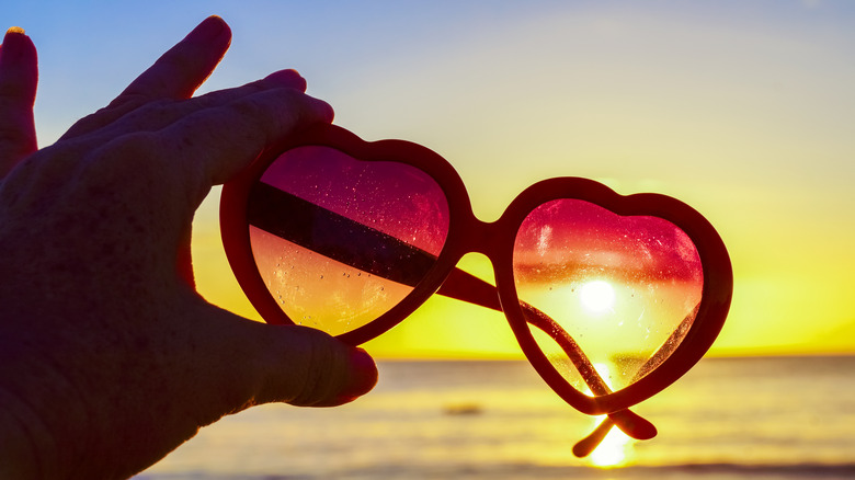 heart shaped sunglasses at beach