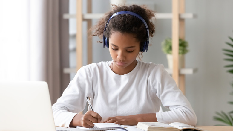 Student writes in notebook