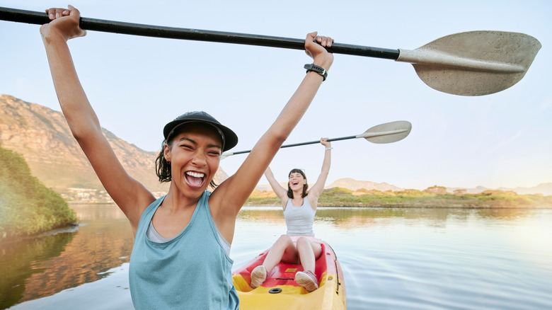 Two women rowing on water