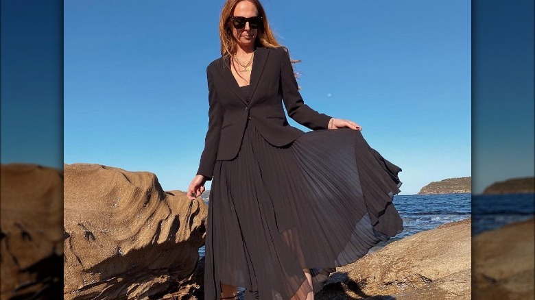 Woman in black midi skirt suit