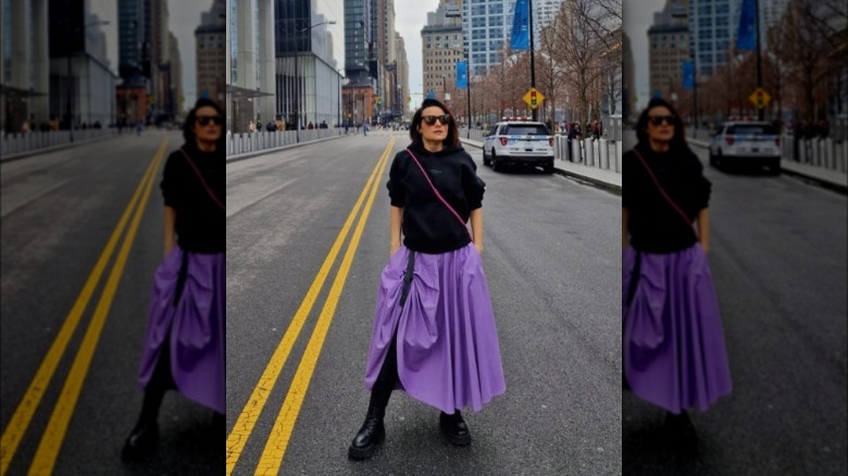 Woman in vibrant purple midi skirt