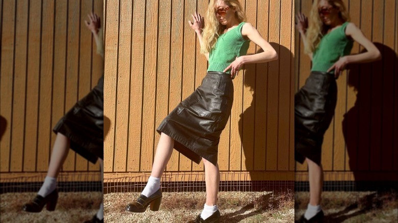 Woman wearing black leather midi skirt