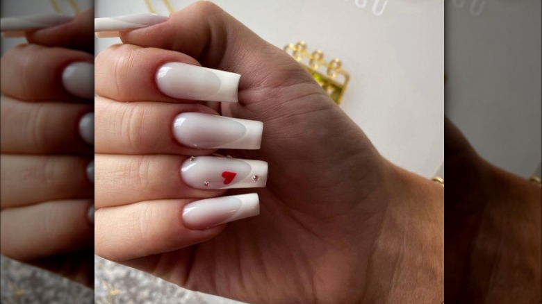 Milky French manicure with embellishments 