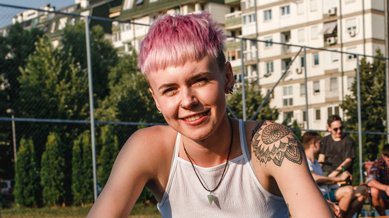 Person with Millennial pink pixie cut