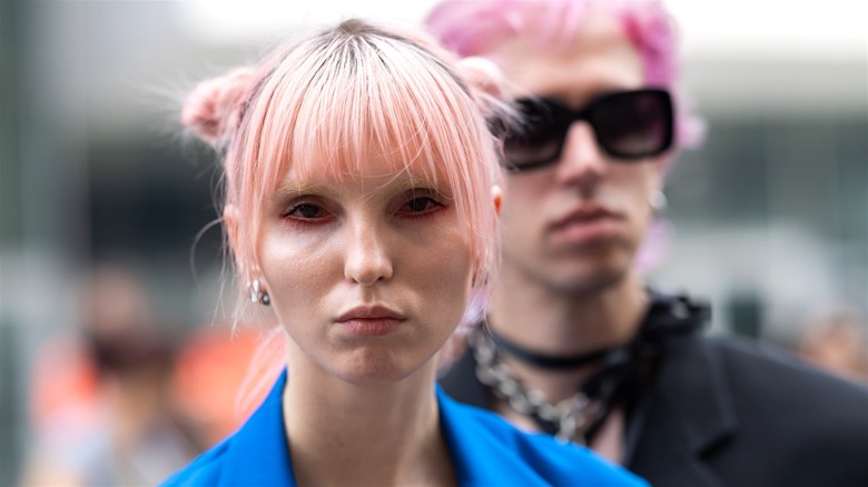 Pink hair woman with bangs and space buns