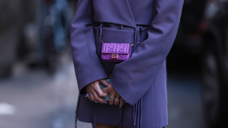 Woman wearing purple mini belt bag