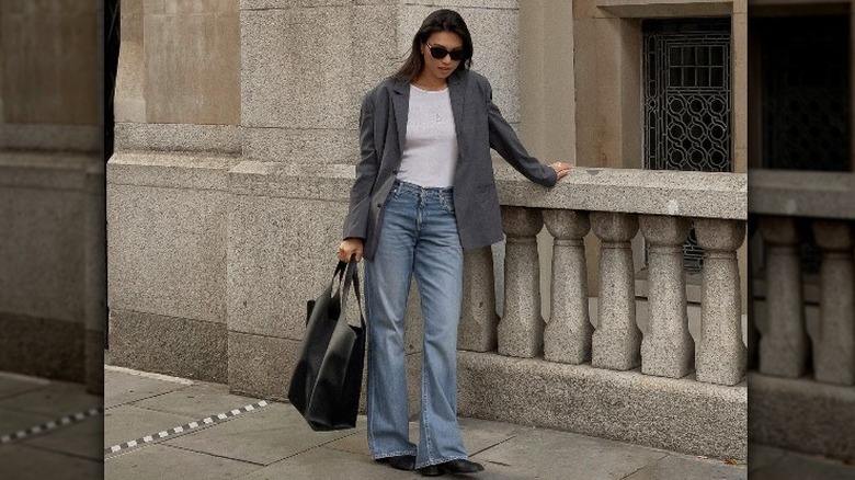 Influencer pairs jeans with gray blazer