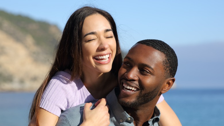 Interracial couple smiling outdoors