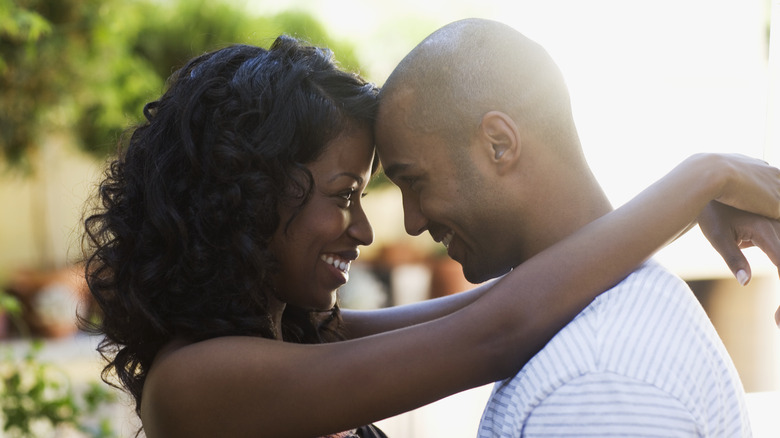 Woman and man hugging, smiling