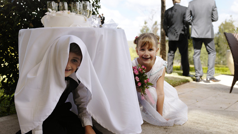 Kids under table at wedding