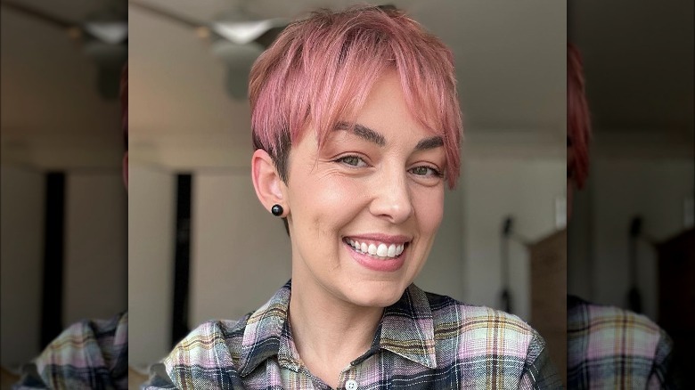 A woman with short pink hair