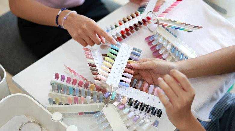 Woman picking nail polish color