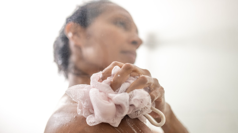 woman washing with loofah 