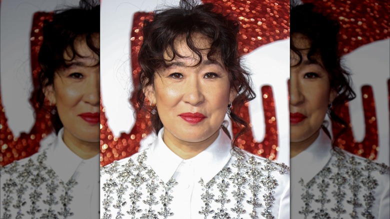 Sandra Oh on the red carpet with curly bangs