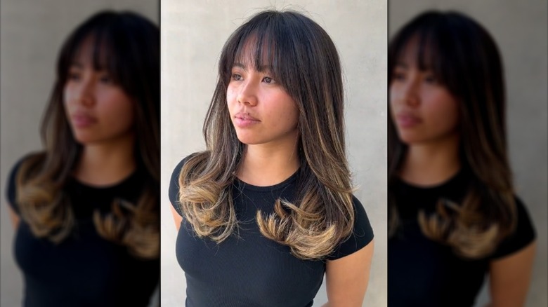 Woman with long hair and wispy bangs