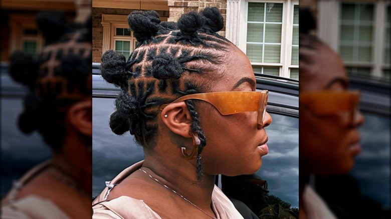 Black woman wearing bantu knots and sunglasses 