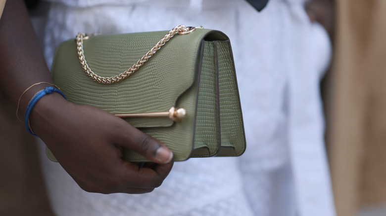 woman holding strathberry bag