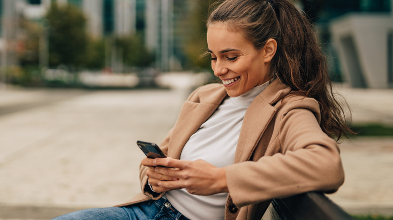 Woman texting outside