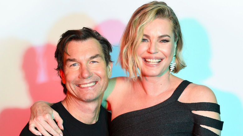 Rebecca Romijn posing for a photo on Jerry O'Connell's lap.