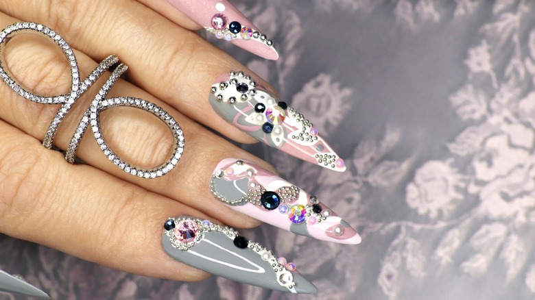 Long, bejeweled pink and gray manicure