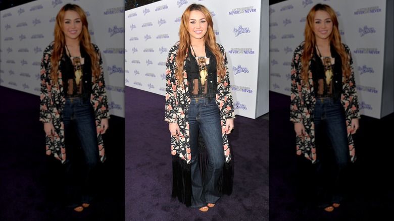 Miley Cyrus wearing floral kimono and bell bottoms