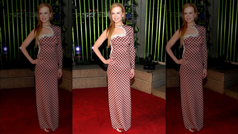 Nicole Kidman in a red-and-white, one-sleeved gown