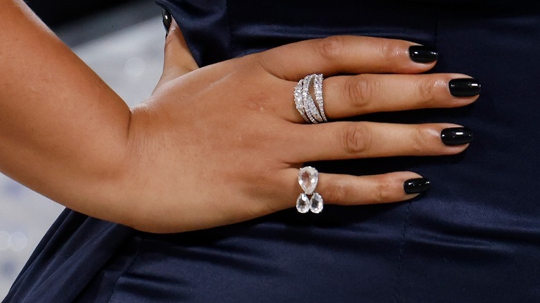 hand with black nail polish on hip