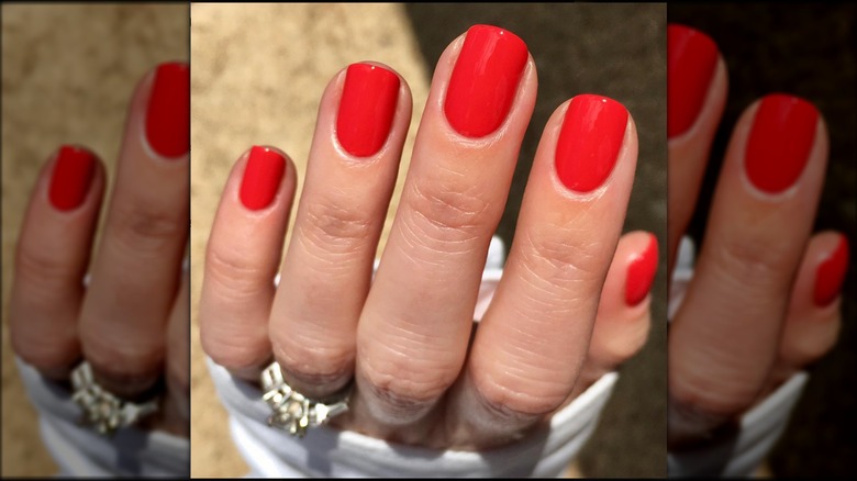 Woman with orange colored fingernails 