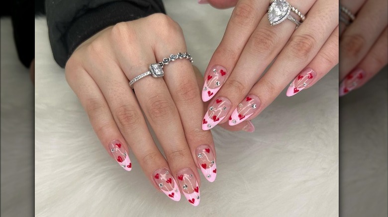 Pink French tip manicure with hearts