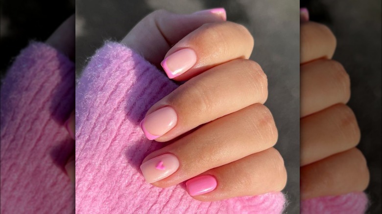 Pink French manicure with heart accents 