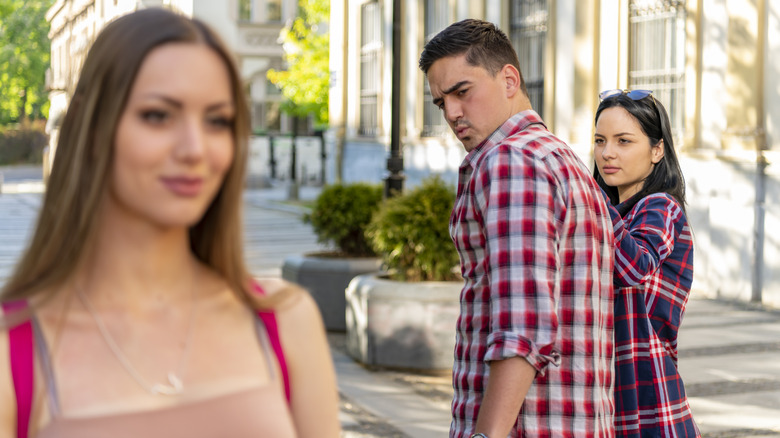 guy checking out other woman