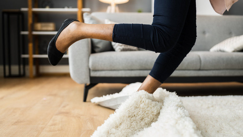 woman tripping on rug