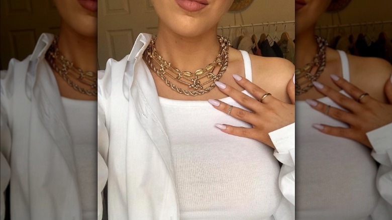 girl wearing chunky gold necklaces