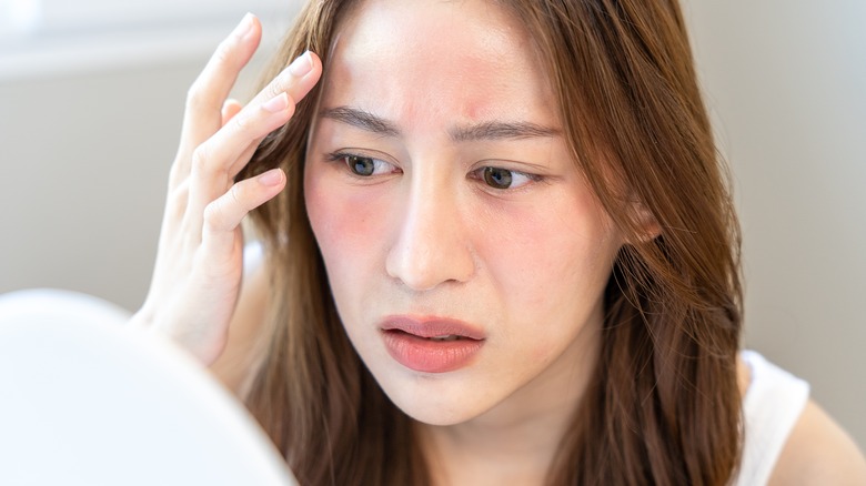 woman looking at irritated skin