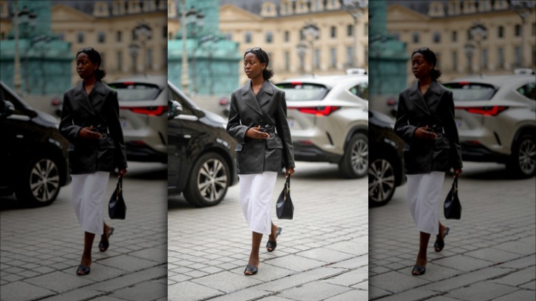 woman wearing black leather blazer and white skirt