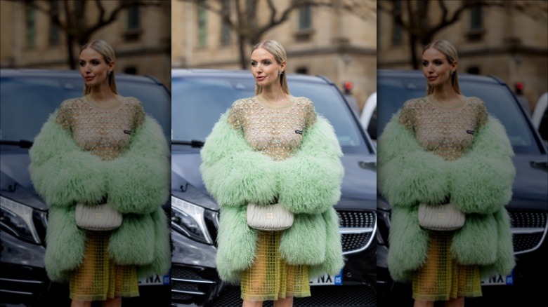 Leonie Hanne wearing sequined top and fur coat