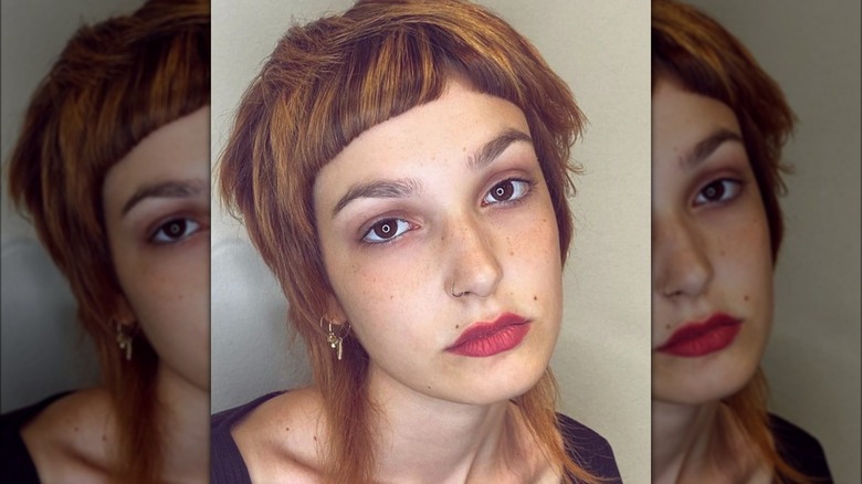 Woman with baby bangs and mullet