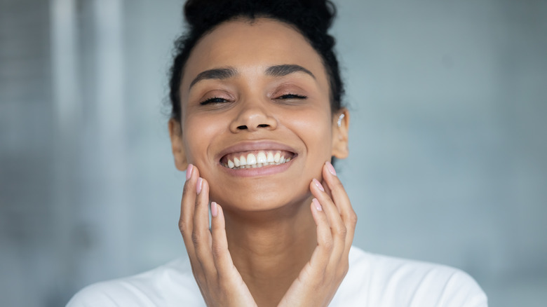 woman washing clean face 