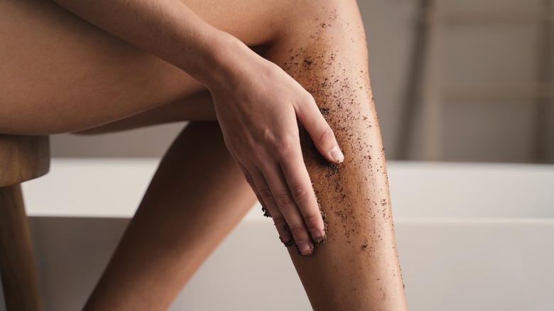 woman scrubbing legs 